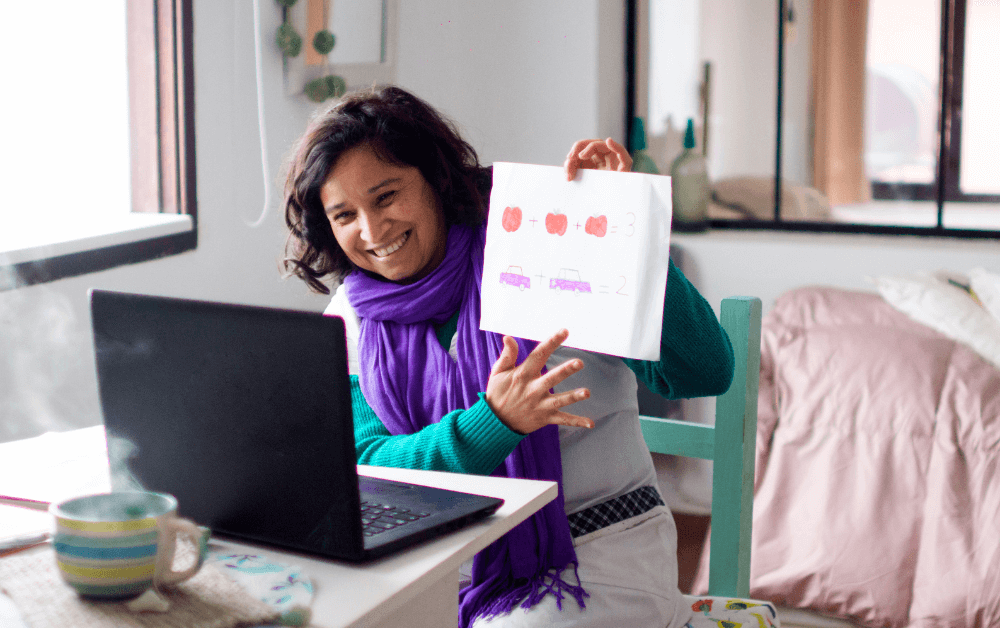 Woman holding up sheet as an online course